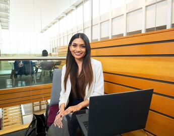 Samiha Hoque sits with her laptop at the Taylor Institute for teaching and learning