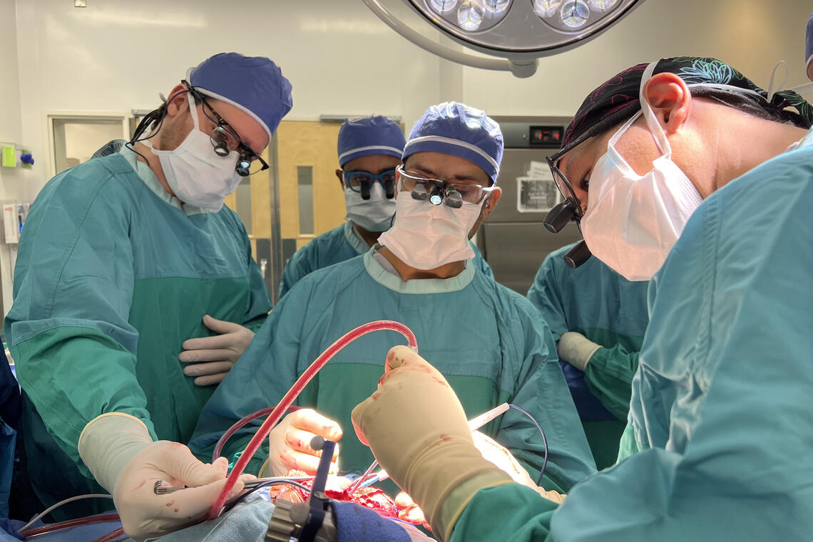 Three doctors performing surgery
