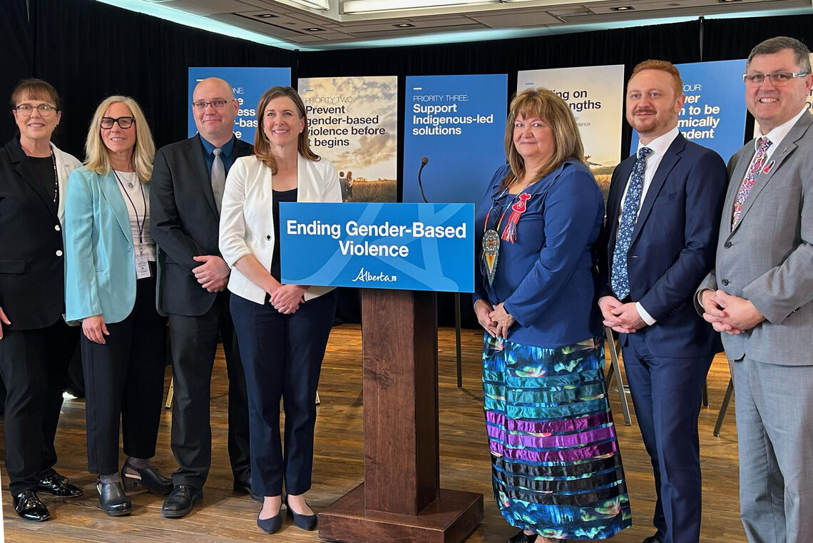A group of people stand around a podium