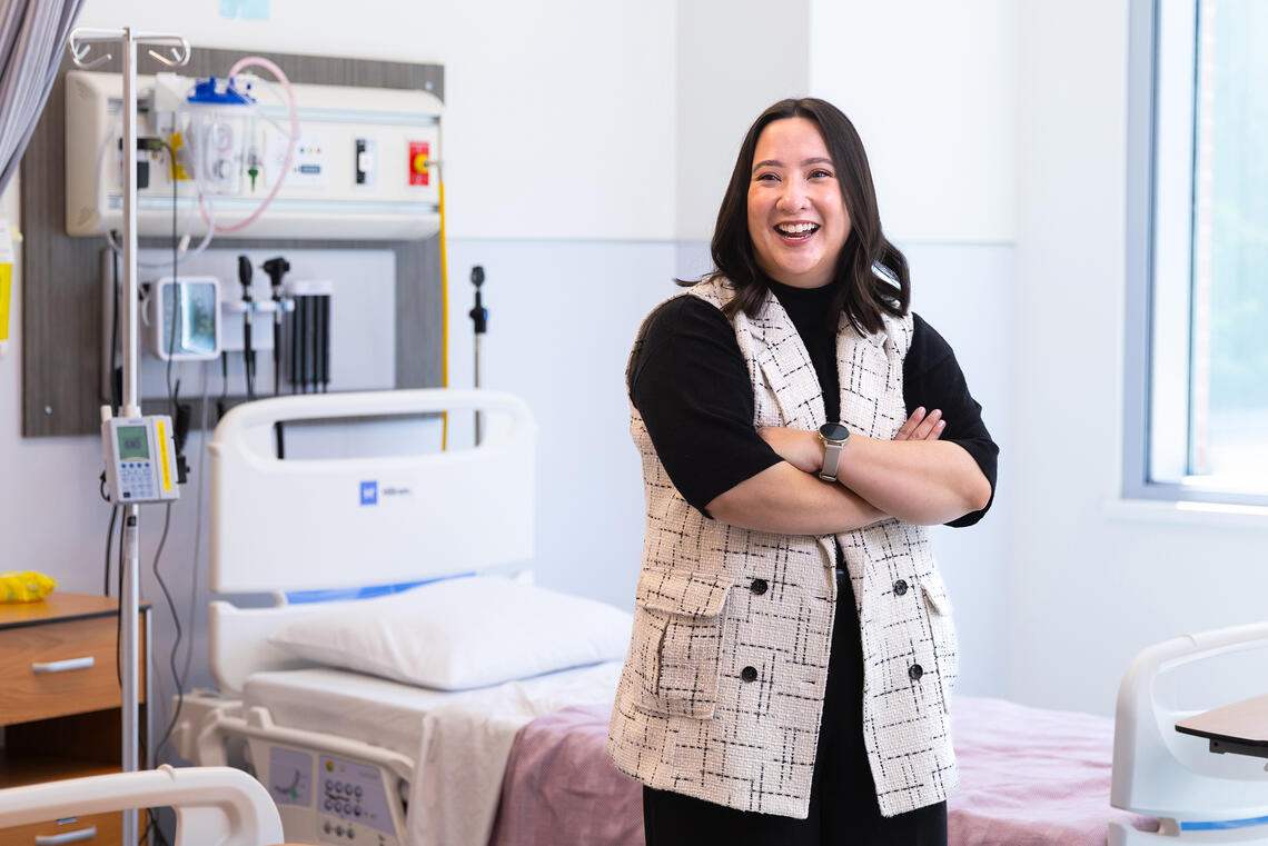 A woman stands in a hospital room