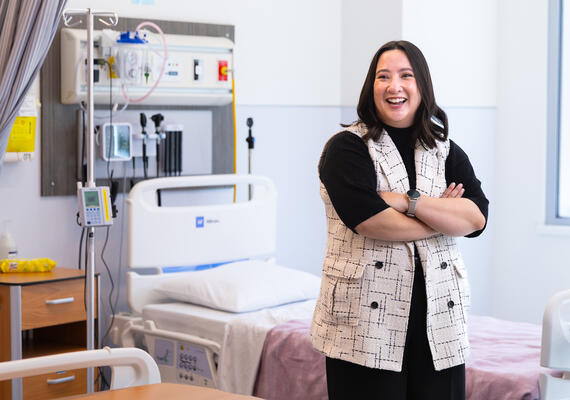 A woman stands in a hospital room
