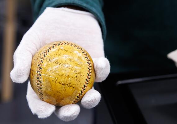 A gloved hand holding a baseball